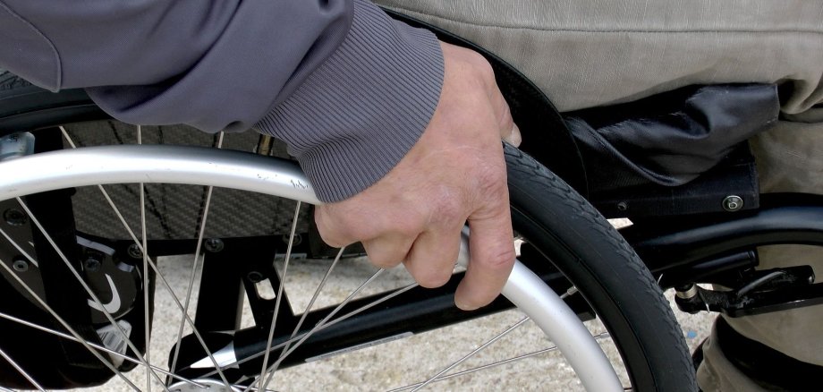 Hand on wheelchair wheel