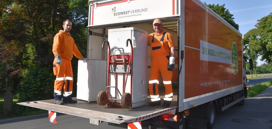 Fridge on the loading area with 2 employees